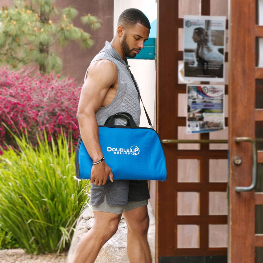 Athlete entering a gym carrying a blue DoubleUP case.