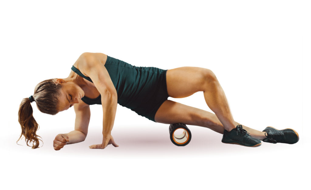 Woman Foam Rolling IT Band on the Ground